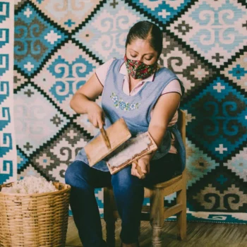 About Us 6 free-photo-of-woman-sitting-on-a-chair-on-the-background-of-a-mosaic-wall